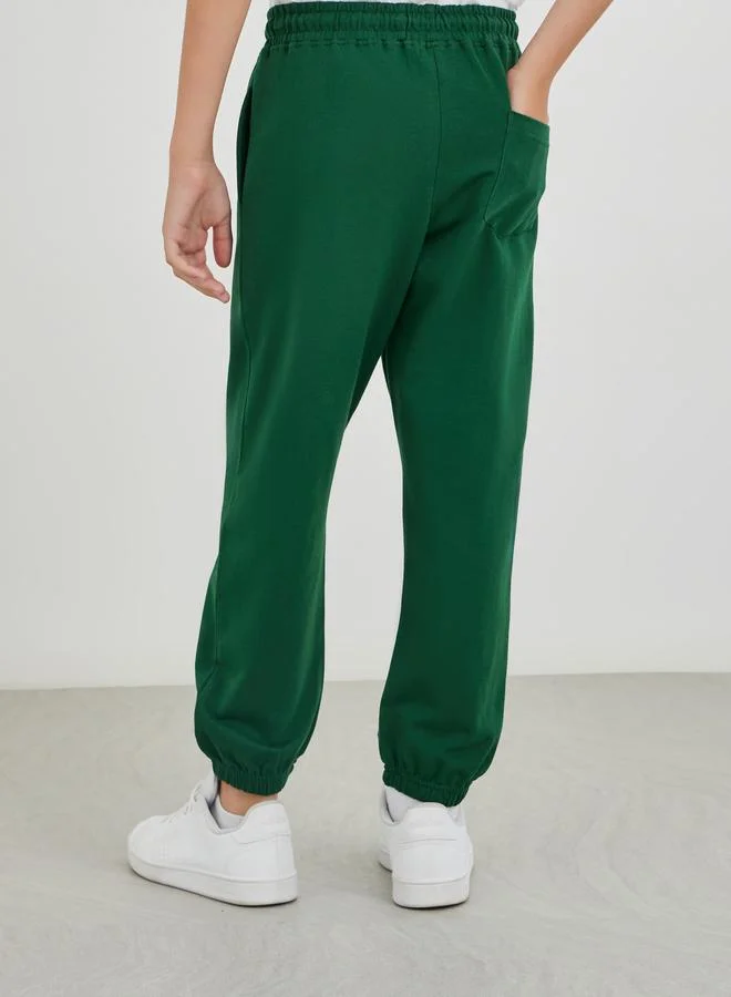 Styli Styli School Uniform Green Solid Cuffed Joggers with Slip Pockets