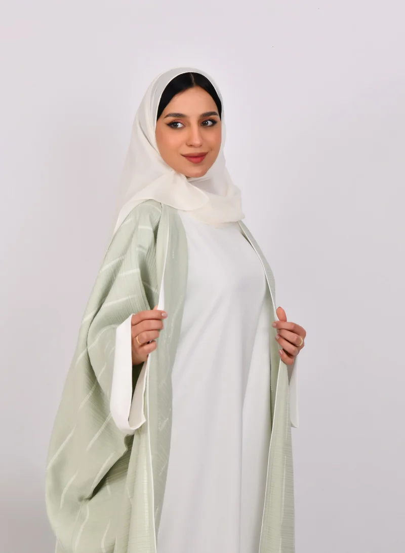 HAWRAA ABAYA Light green wide sleeve abaya with white stripes and a white dress
