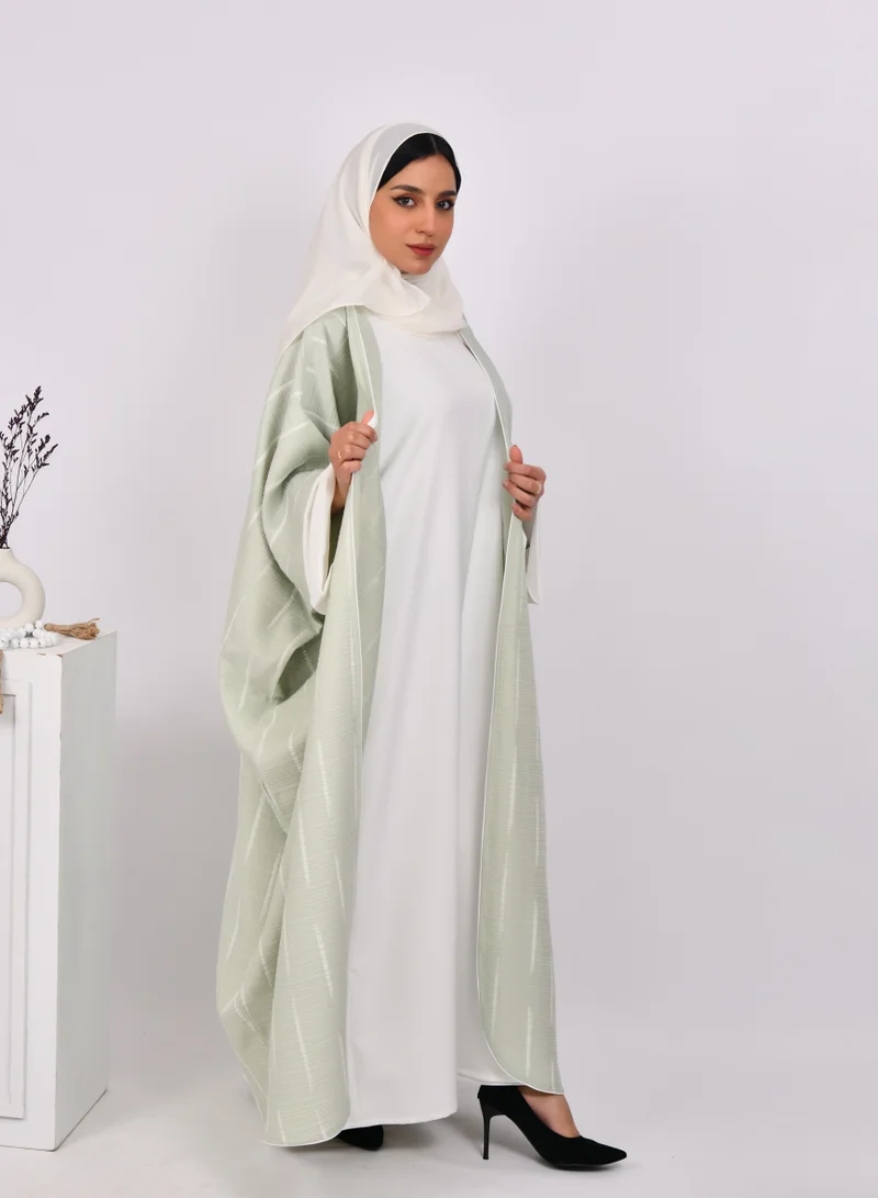 HAWRAA ABAYA Light green wide sleeve abaya with white stripes and a white dress