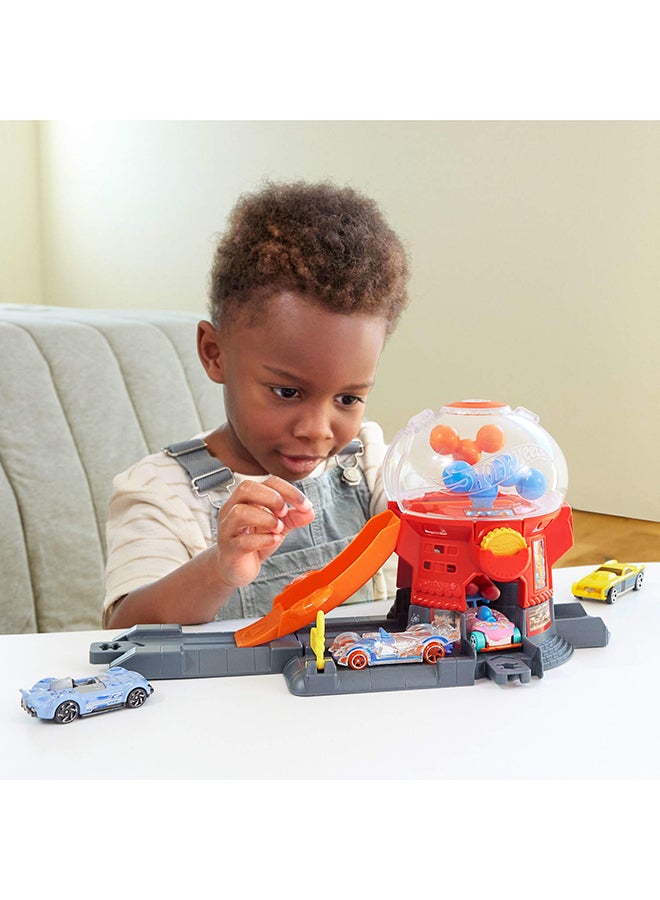 Hot Wheels Toy Car Track Set, Gumball Machine Playset with 1:64 Scale Die-Cast Donut-Shaped Vehicle & Speed Snap Track, Downtown City Candy Shop - Image 3