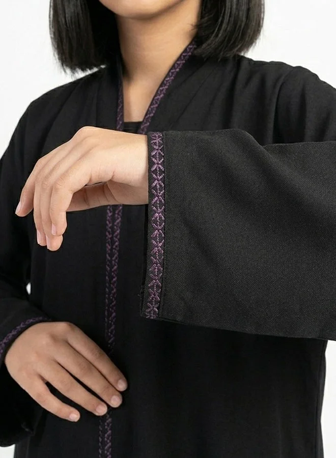 HAWRAA ABAYA Black girls’ wrap abaya featuring delicate purple embroidery along the edges