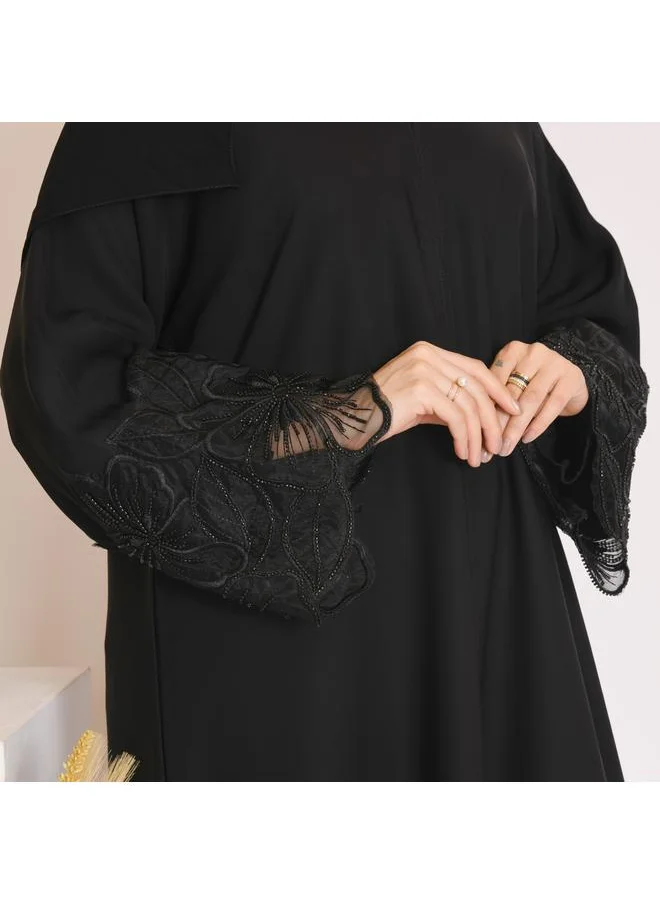 HAWRAA ABAYA Black abaya with closed buttons and decorated with embroidery on the sleeves and bottom of the abaya