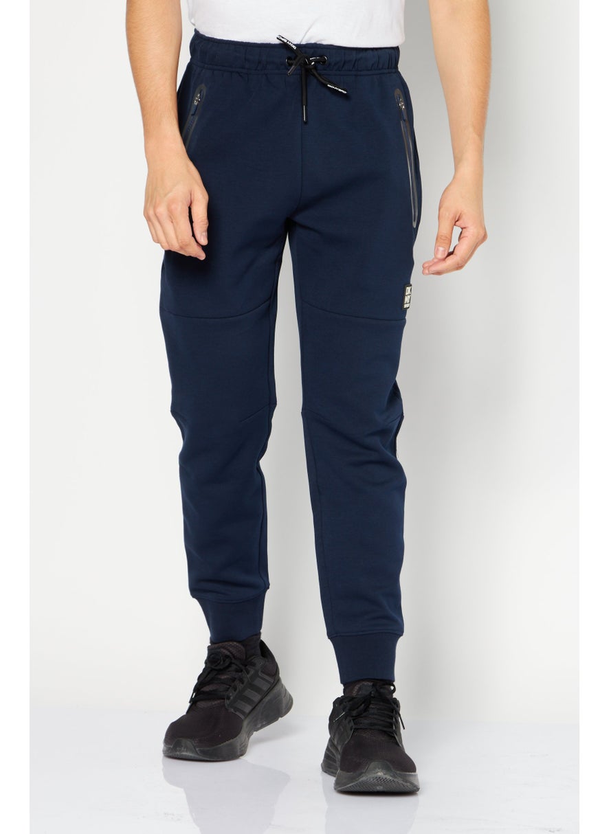DKNY Sport Men Sportswear Fit Brand Logo Training Jogger Pant, Navy Blue  - Image 1