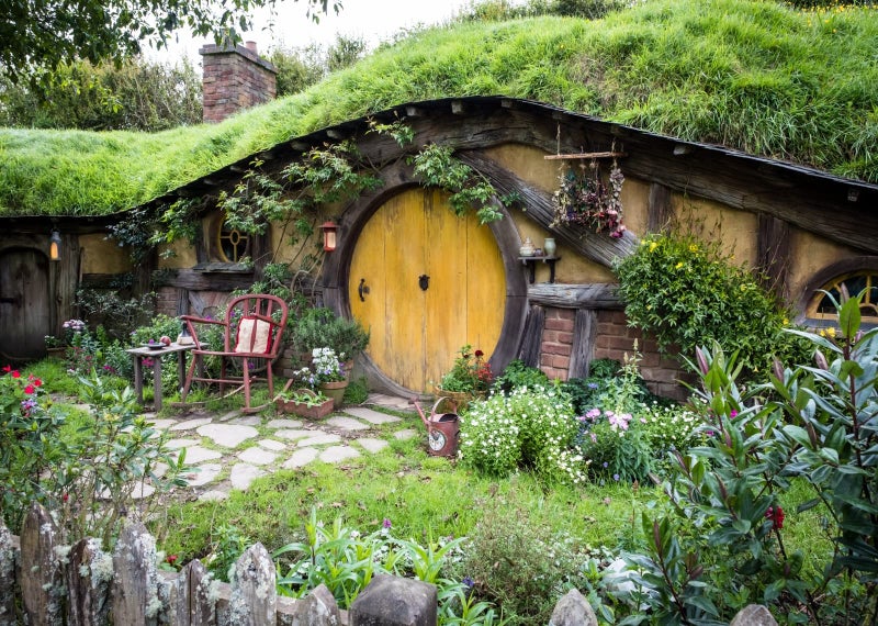 BELECO 7x5ft Fabric Hobbiton Cave Backdrop Matamata Rural Living Cabin Green Grass Garden for Hobbit Decor Background for Ring Lord Fans Party Birthday Party Decorations Banner Photo Props - Image 1