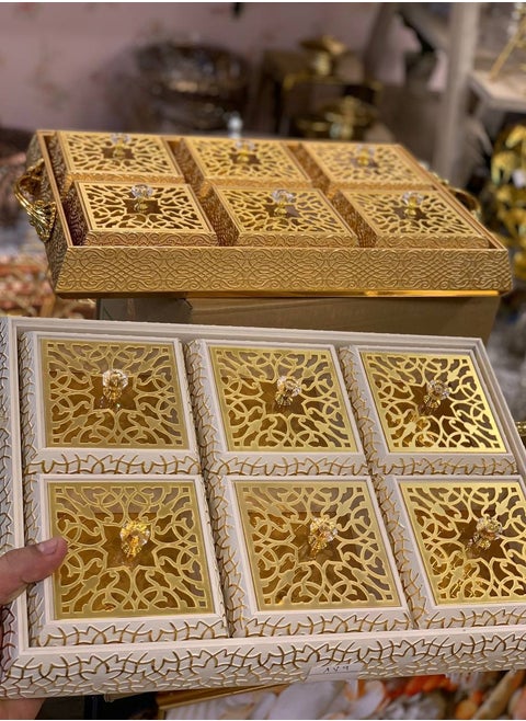 A serving set for Chinese nuts and snacks, including 6 square boxes of snacks and nuts, made of raw wood in leather.
