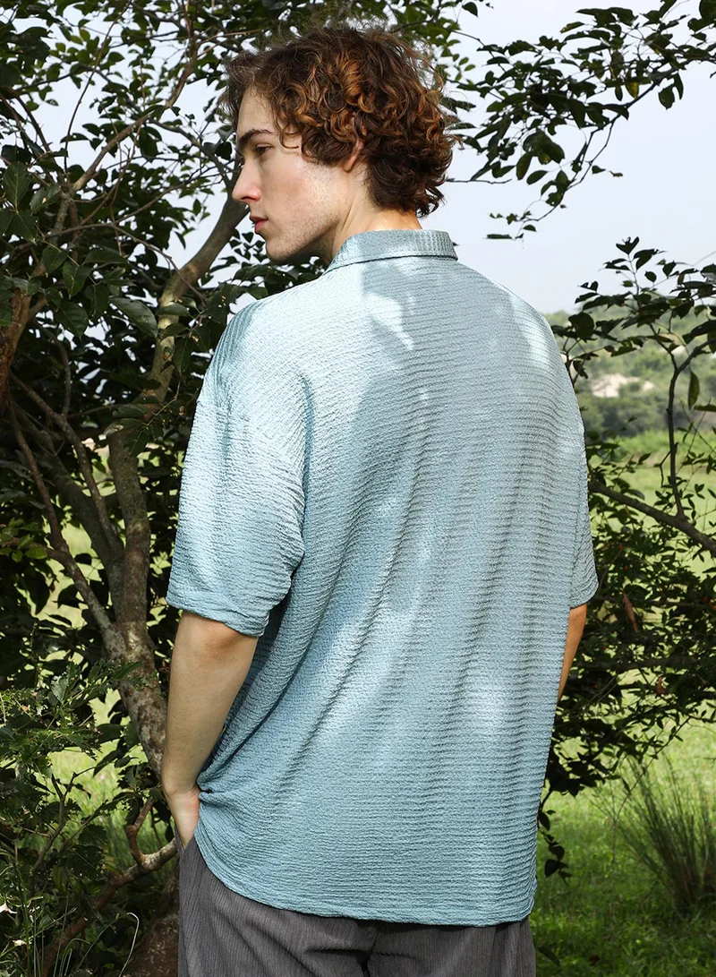 Campus Sutra Campus Sutra Men's Sage Green Tactile-Utility Oversized Shirt For Casual Wear | Spread Collar | Short Regular Sleeves | Button Closure | Oversized Shirt Crafted With Comfort Fit For Everyday Wear