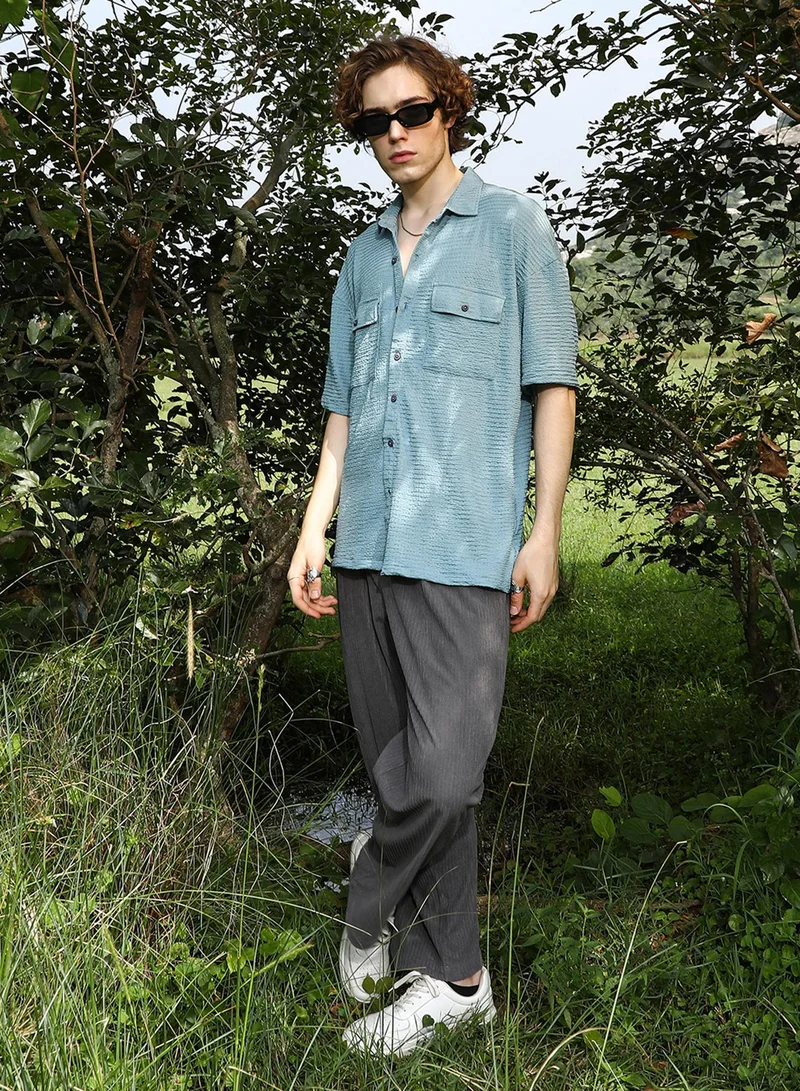 Campus Sutra Campus Sutra Men's Sage Green Tactile-Utility Oversized Shirt For Casual Wear | Spread Collar | Short Regular Sleeves | Button Closure | Oversized Shirt Crafted With Comfort Fit For Everyday Wear