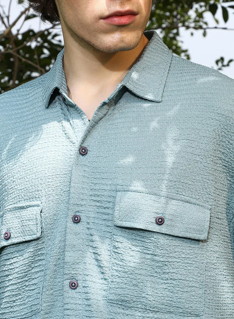 Campus Sutra Campus Sutra Men's Sage Green Tactile-Utility Oversized Shirt For Casual Wear | Spread Collar | Short Regular Sleeves | Button Closure | Oversized Shirt Crafted With Comfort Fit For Everyday Wear
