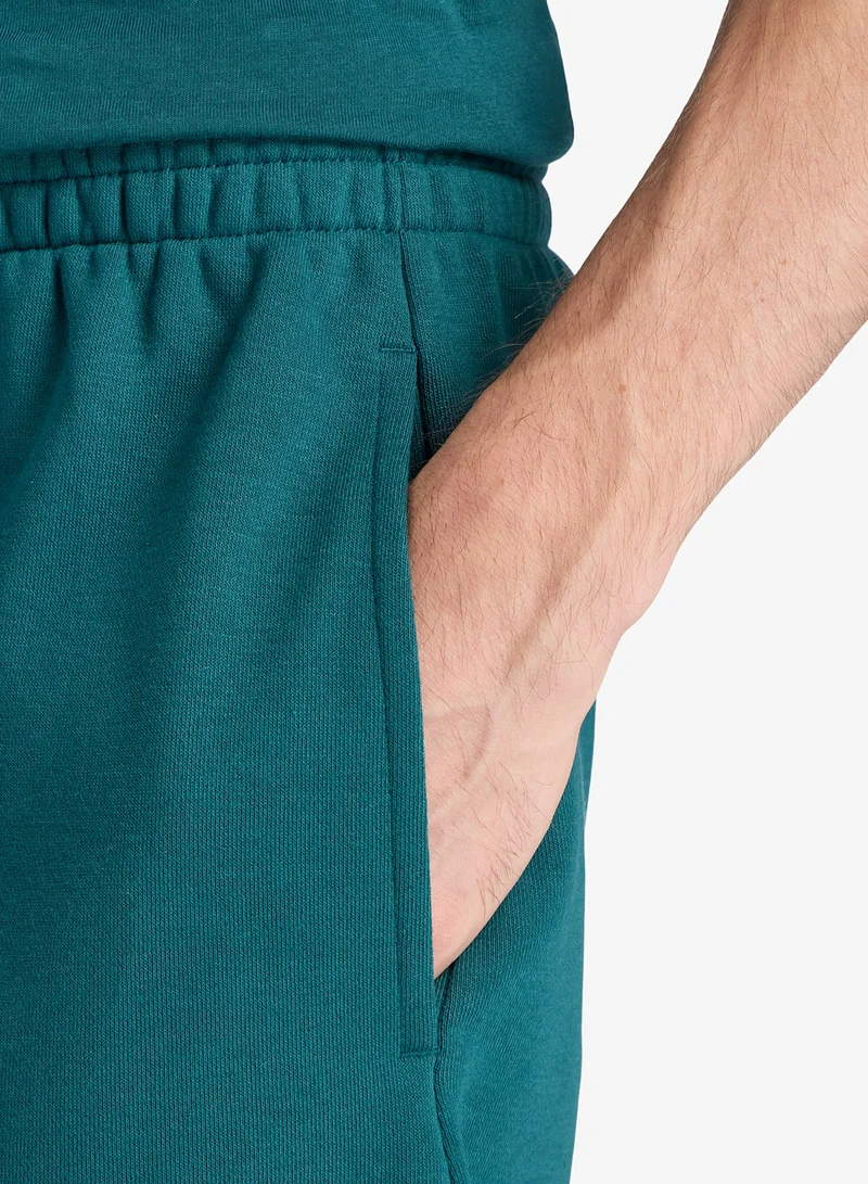 New Balance MEDUSA GREEN (AAV) 7" Essential French Terry Shorts for Men | Best Price UAE