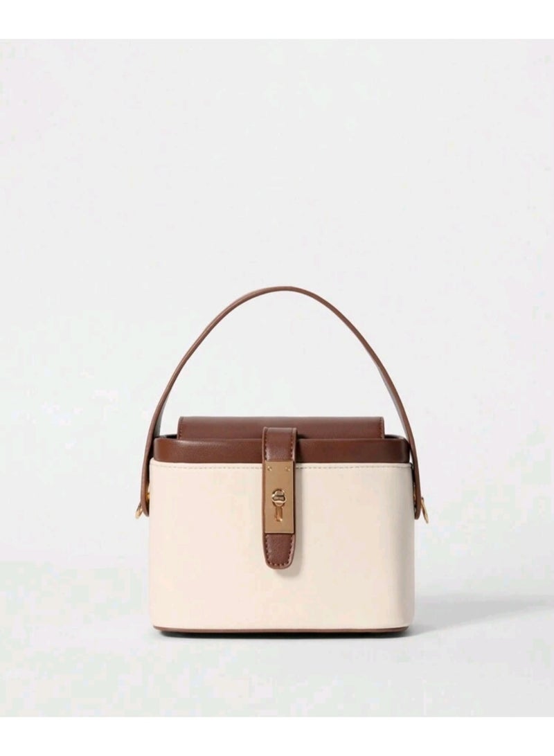 arab Women's handbag with a modern and elegant design. Features a chic beige and dark brown color combination with a gold-tone lock and adjustable shoulder strap. Perfect for daily use or special occasions, with a practical design that fits your essentials.  Dimensions: 10.5 cm (Height) × 17 cm (Width) × 13 cm (Depth)  Color: Beige and Brown  Gold-tone metal lock  Top handle and removable shoulder strap - Image 1