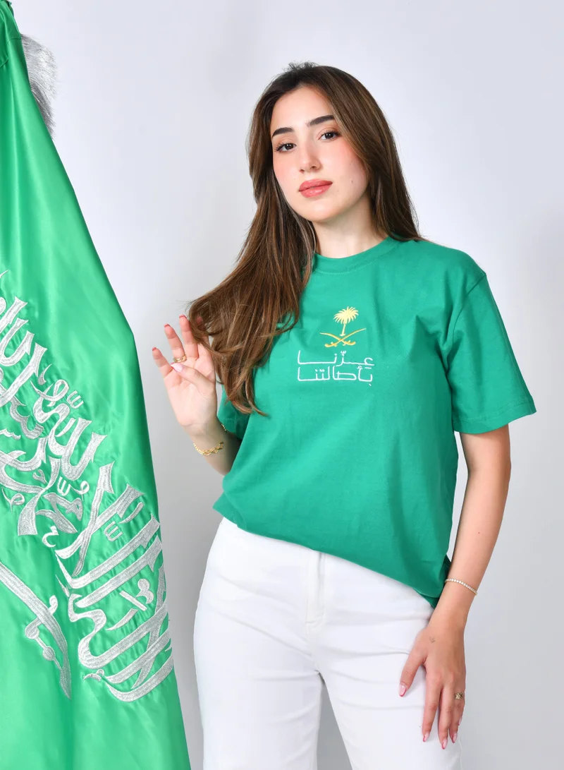 HAWRAA ABAYA Green T-shirt with the slogan "Our Pride is in Our Authenticity" embroidered on it