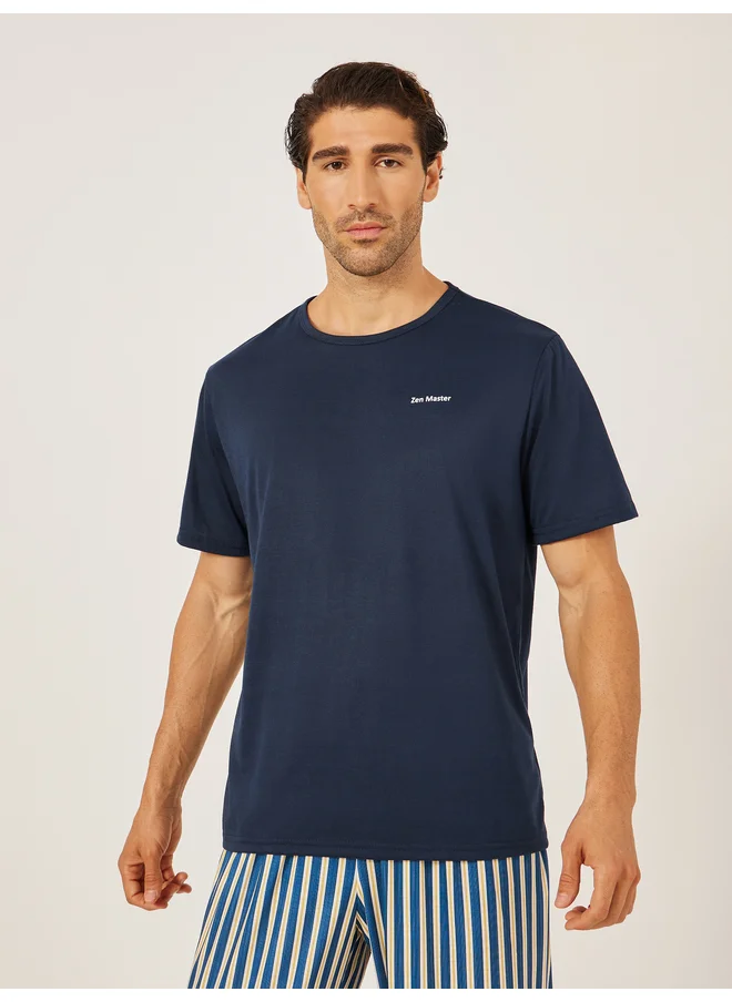 Styli Styli Unwind Minimal Printed T-Shirt and Striped Badge Detail Pyjama Set