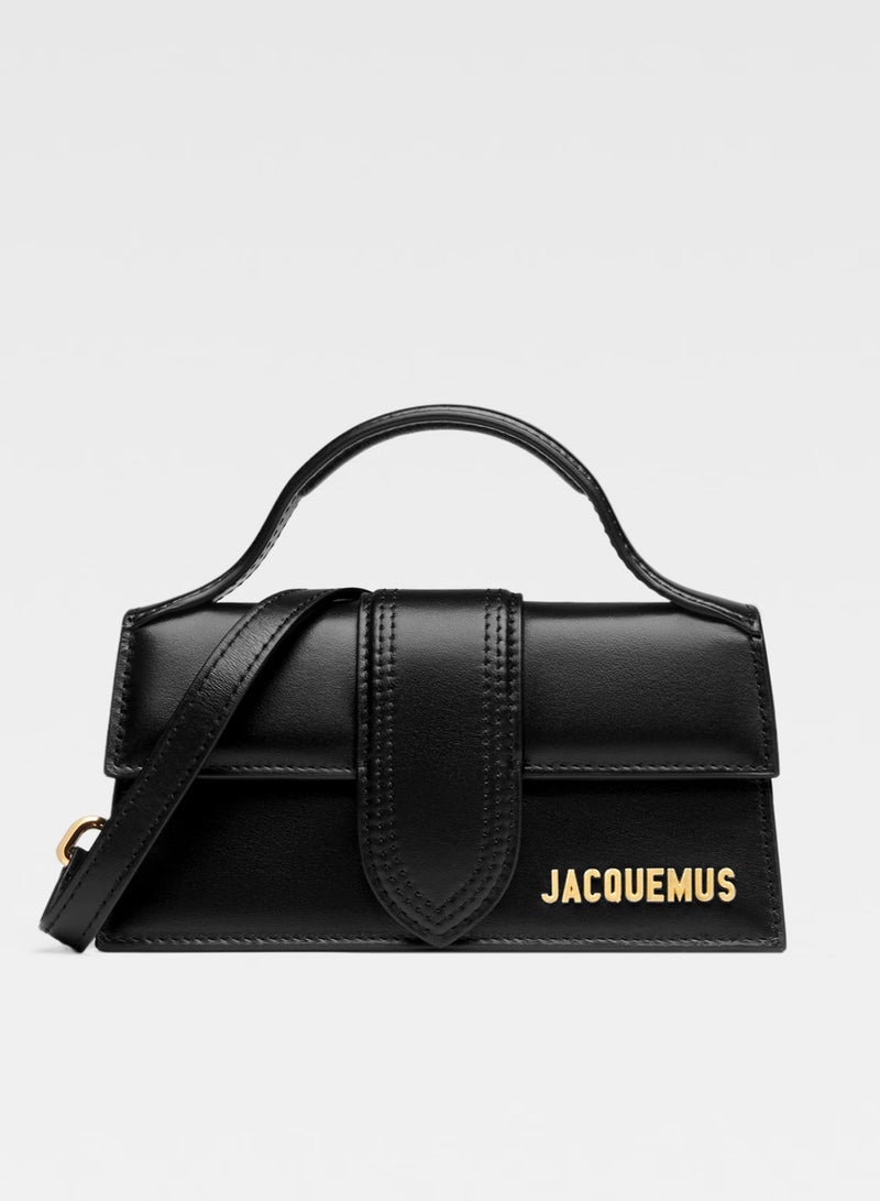 Jacquemus  حقيبة جاكيموس ذا بامبينو ذات غطاء وحزام قابل للفصل، حقيبة يد نسائية، حقيبة كتف نسائية، حقيبة توت نسائية، حقيبة سفر نسائية، أسود لامع - ١٧ سم - Image 1