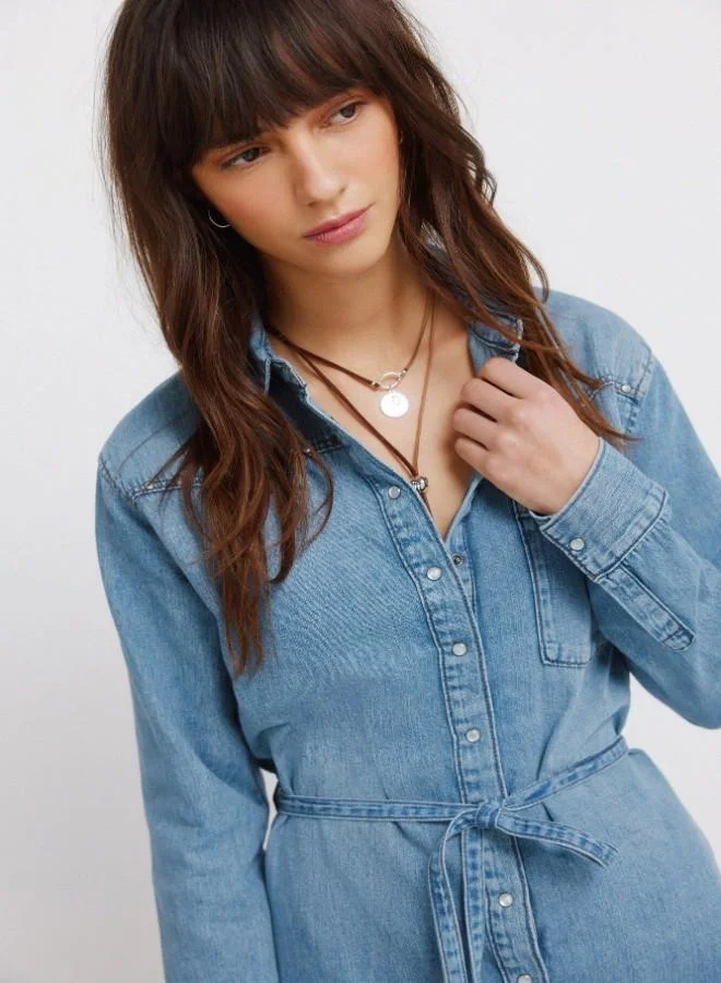 Springfield  Denim short dress. Shirt collar. Front button and cuff fastening. Waist belt detail. V-shaped yoke. Studs on yoke. A washing process has been used with new technologies, reducing water, chemical and energy consumption. for Women | Best Price UAE