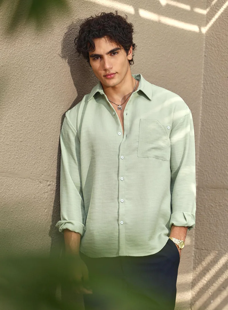 Campus Sutra Campus Sutra Men's Sage Green Modular Solid Oversized Shirt For Casual Wear | Spread Collar | Long Cuffed Sleeves | Button Closure | Oversized Shirt Crafted With Comfort Fit For Everyday Wear