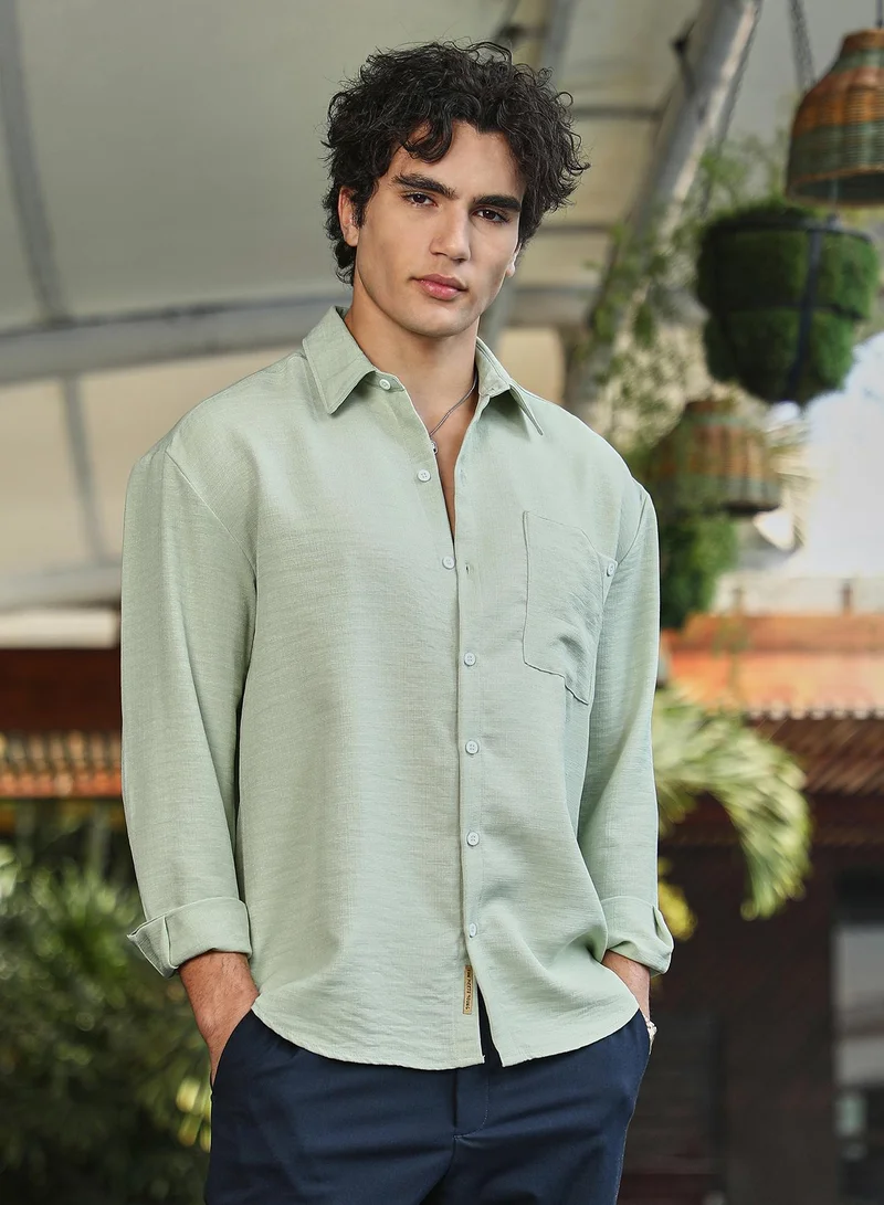 Campus Sutra Campus Sutra Men's Sage Green Modular Solid Oversized Shirt For Casual Wear | Spread Collar | Long Cuffed Sleeves | Button Closure | Oversized Shirt Crafted With Comfort Fit For Everyday Wear