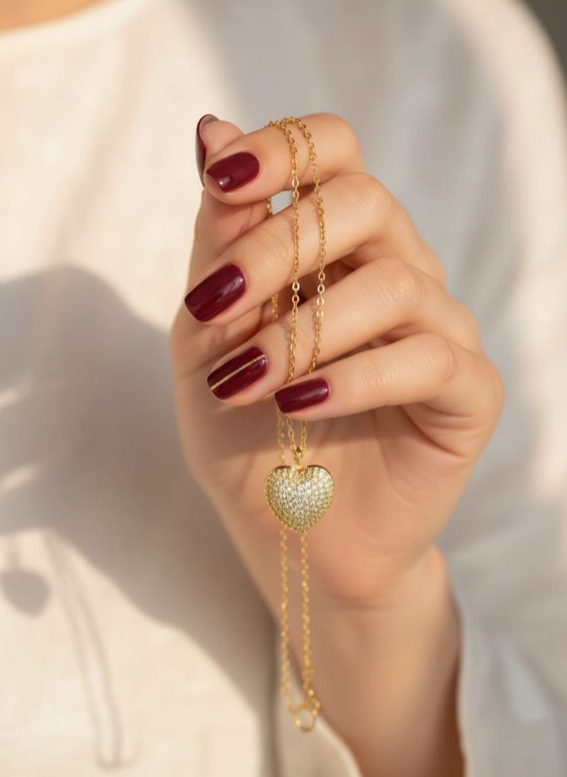 A fully covered, prominent heart-shaped necklace with sparkly, glittery detailing - on a delicate gold-plated chain - with additional links for adjusting the size. - Image 2