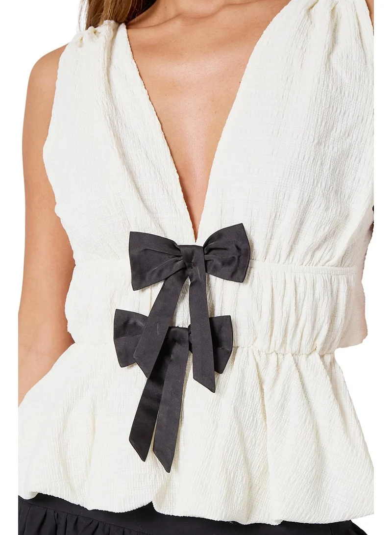 Urban Bliss White V Neck Sleeveless Peplum Top with Bow Details