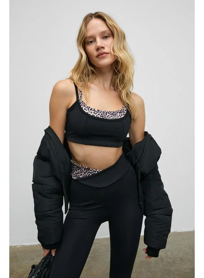 URBAN BEAT BLAZIX Women's Flexible and Soft Textured Leopard-Contrast Sports Bra with Adjustable Ring Straps in Black.