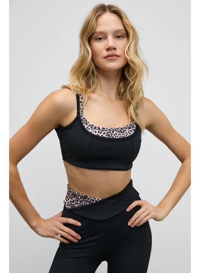 URBAN BEAT BLAZIX Women's Flexible and Soft Textured Leopard-Contrast Sports Bra with Adjustable Ring Straps in Black.