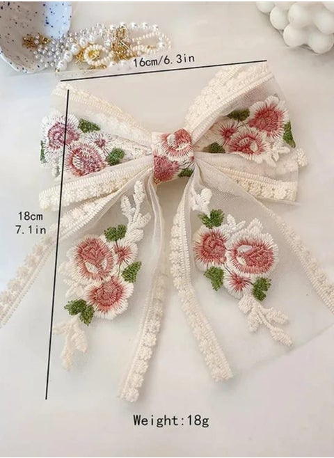 Elevate your look with this luxurious beak hair clip featuring a large bow and elegant floral embroidery! This hair clip adds a soft, romantic touch to your hair. Made from sheer lace embroidered with roses, it's secured with a practical and easy-to-use beak clip. Perfect for special occasions or to pair with a classic, charming look.