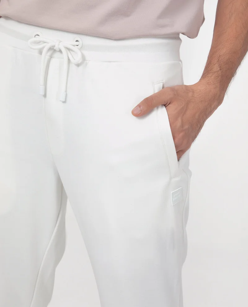 Rare Rabbit Rare Rabbit Men's Toyo Off White Cotton Polyester Fabric Drawstring Closure Regular Fit Mid Rise Trackpant