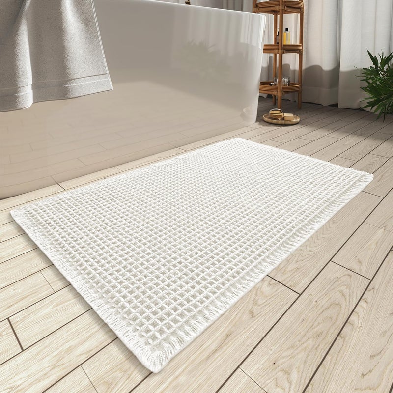 AMOAMI Upgraded Waffle Bath Mat, Super Absorbent Non Slip Bath Mats for Bathroom Floor, Machine Washable Bathroom Rugs with Tassels, Rubber Backed Bathroom Mats, Ultra Soft, 17" x 24", White - Image 1