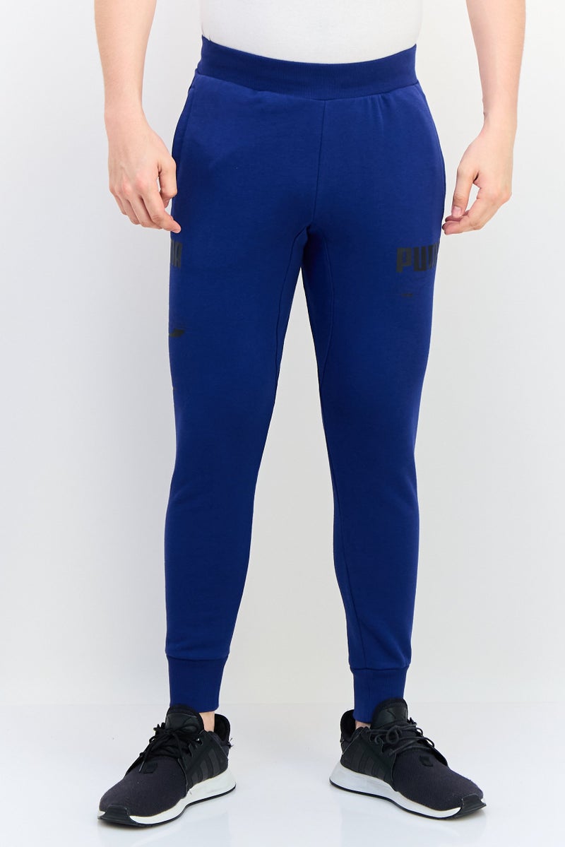 PUMA سروال رياضي خارجي للرجال بقصة عادية مع شعار العلامة التجارية، أزرق - Image 1