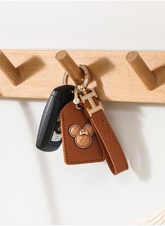 KeyAmor Elegant metal and quilted leather keychain for car keys includes a matching AirTag holder stylish design with golden crystal rings perfect for women has three key rings    light brown leather spins 360 degrees and comes in a  gift box  - Image 1