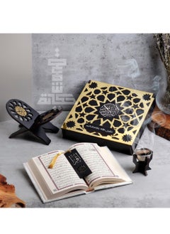 A box of the Holy Qur’an with an incense burner and a Qur’an holder with the Qur’an and a reading break