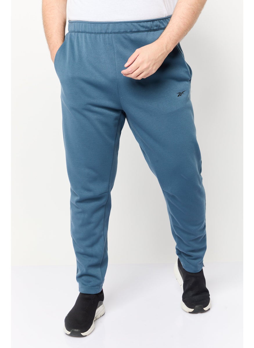 Reebok Men Sportswear Fit Brand Logo Outdoor Sweatpants, Teal Blue  - Image 1