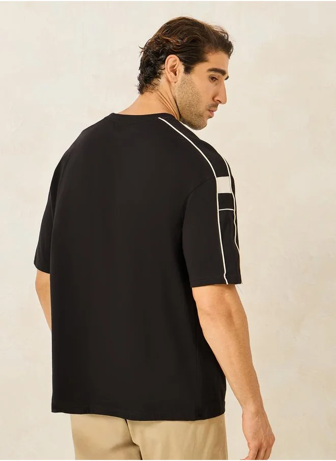 ستايلي Styli Compact Jersey Piping Shoulder Detail Oversized T-Shirt with Chest Print