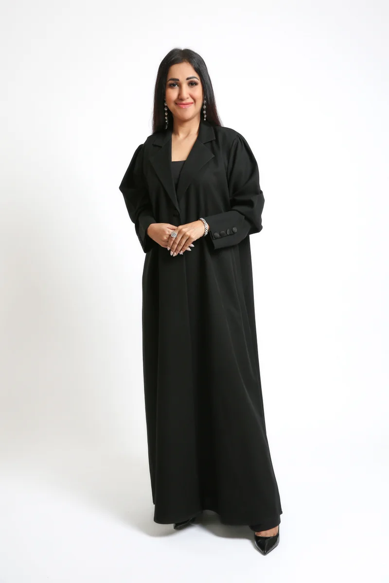 Nikias A sleek Black Crepe Overlap Abaya designed with signature loop accents along the front and sleeves