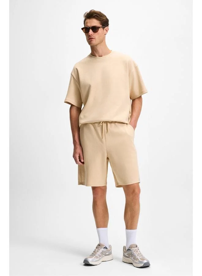 Grimelange BAILEY Men's Elastic Waist Single Back Pocket Corded Relaxed Fit Beige Shorts.