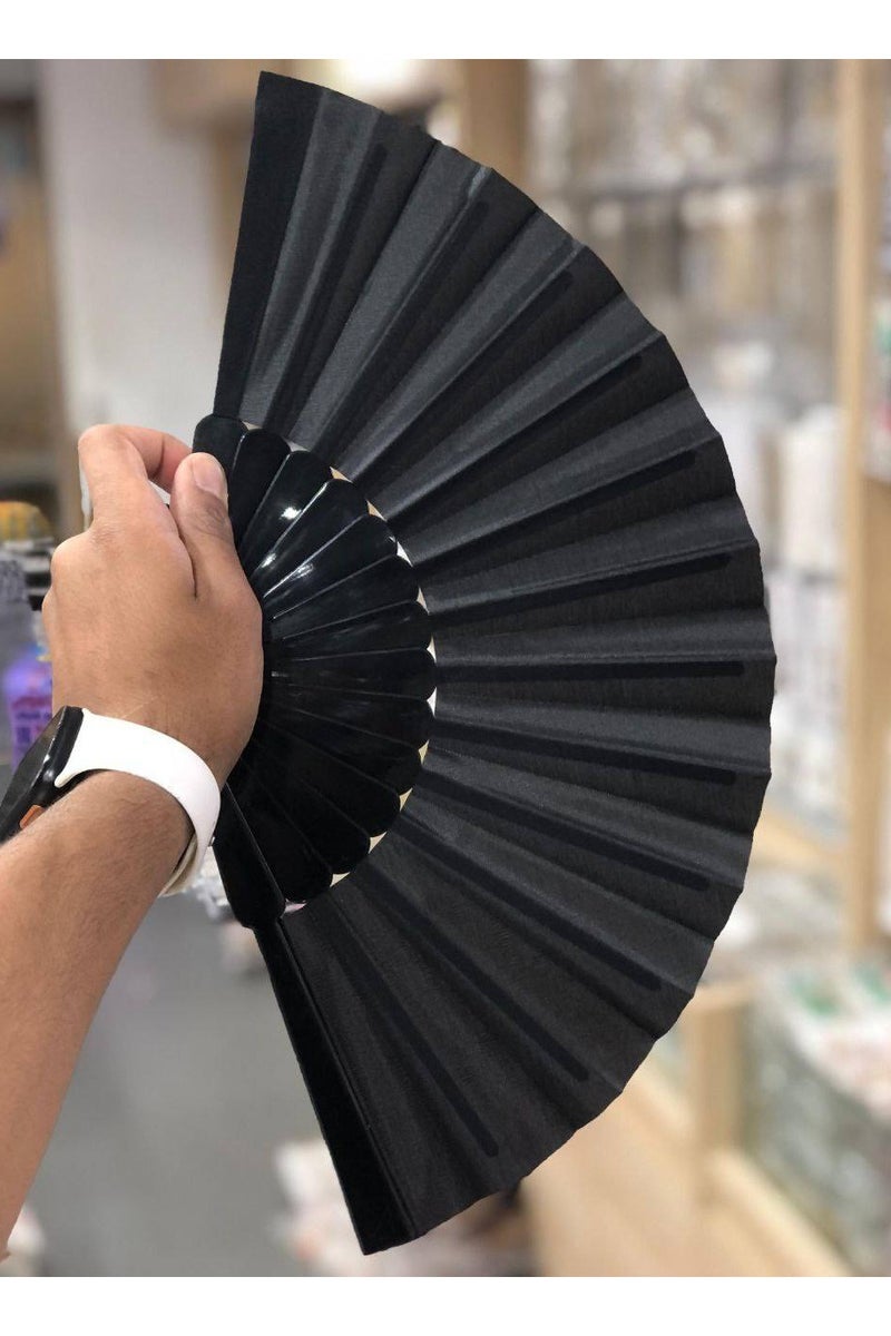 An elegant, modern, foldable hand fan. Classic black color exudes luxury and simplicity. Lightweight and easy to carry, ideal for hot, summer weather. A practical and beautiful addition to your everyday or formal look.  - Image 1