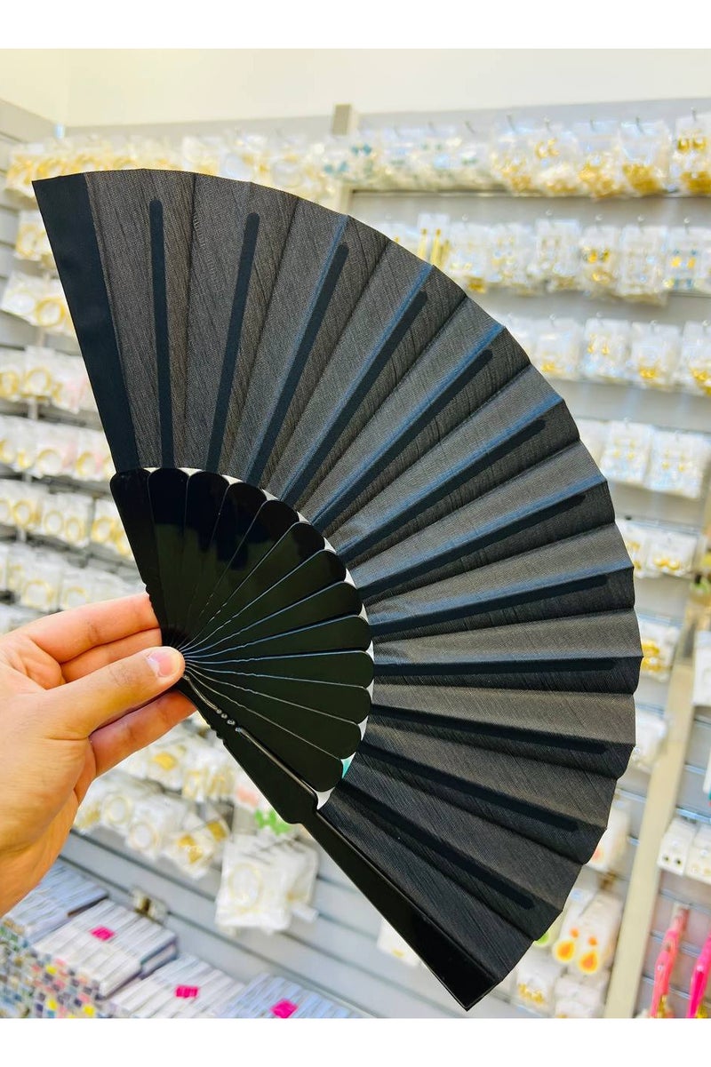 An elegant, modern, foldable hand fan. Classic black color exudes luxury and simplicity. Lightweight and easy to carry, ideal for hot, summer weather. A practical and beautiful addition to your everyday or formal look.  - Image 2