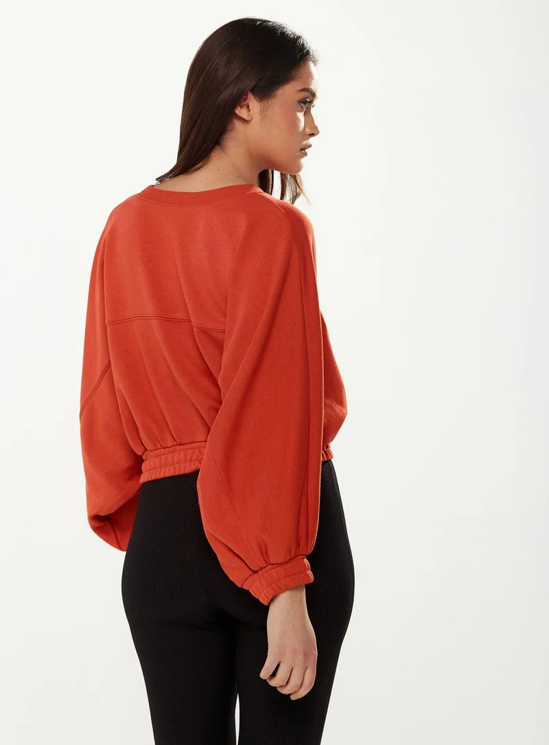 Liquorish Cropped Sweatshirt in Orange