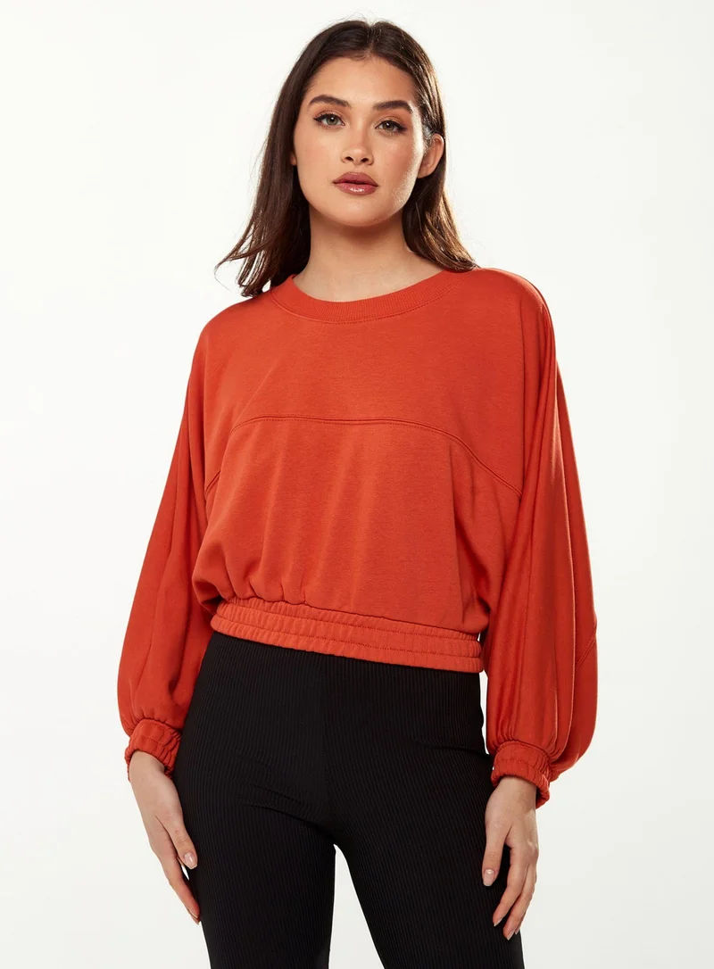 Liquorish Cropped Sweatshirt in Orange
