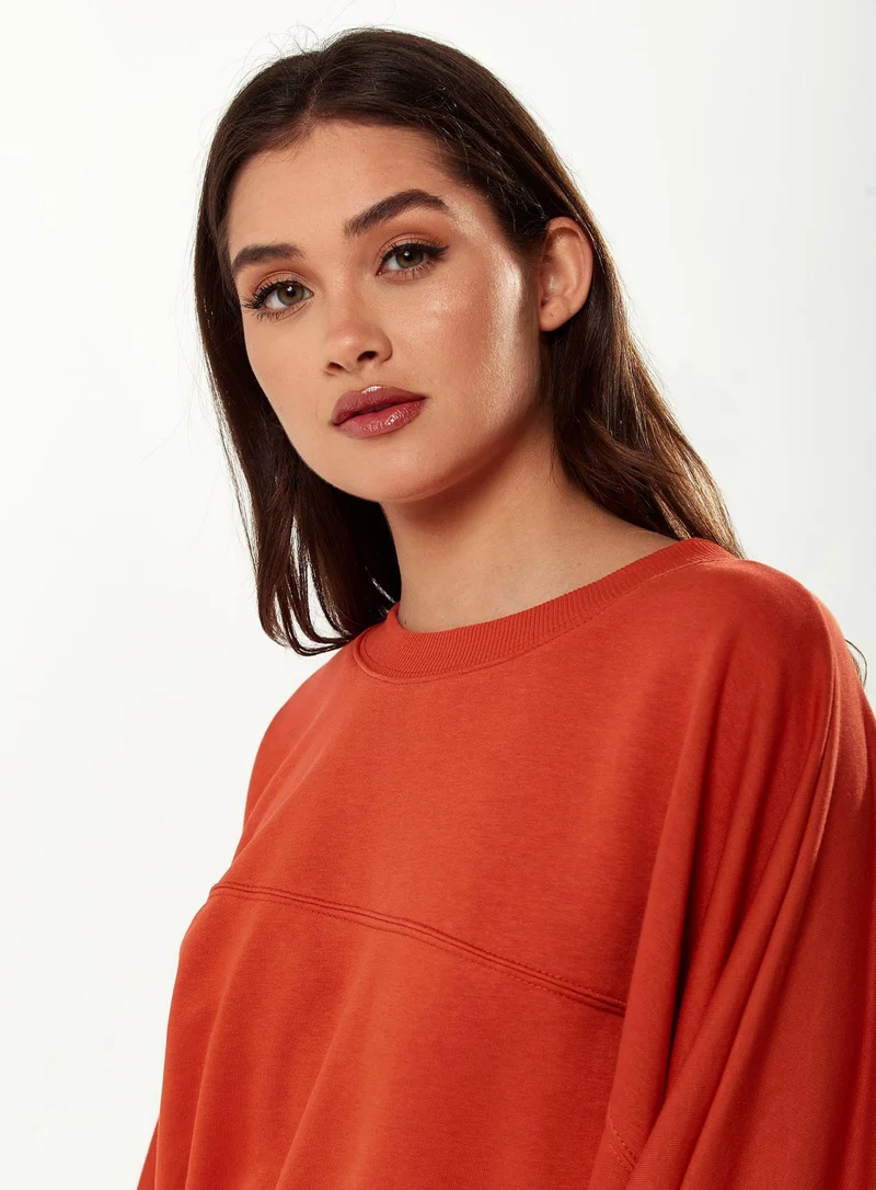 Liquorish Cropped Sweatshirt in Orange