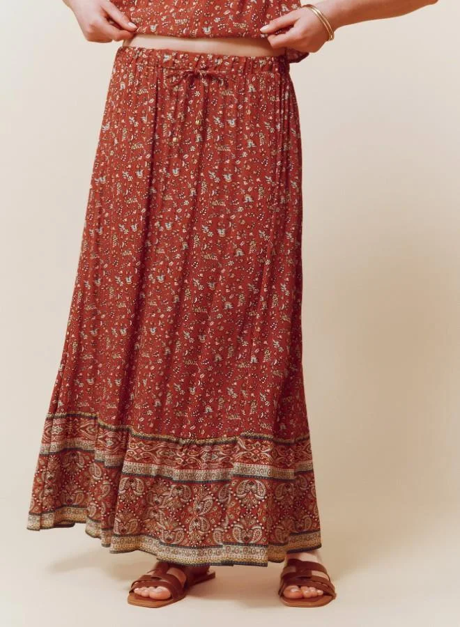 Springfield  Sustainable viscose midi border print skirt with elasticated waistband and drawstring with tassel detail for Women | Best Price UAE
