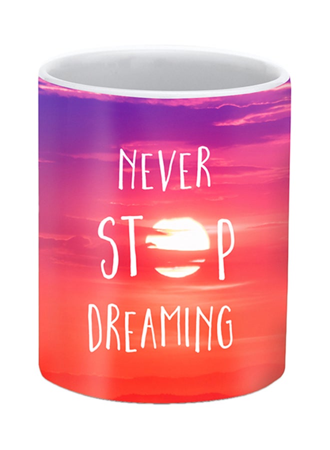 Stylizedd Never Stop Dreaming Printed Ceramic Mug Red/Orange/Pink - Image 1