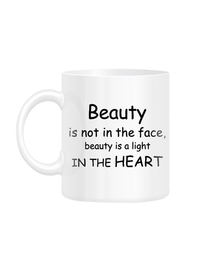 قدح أبيض مطبوع عليه اقتباس "Beauty is not in the face" أبيض 10سم