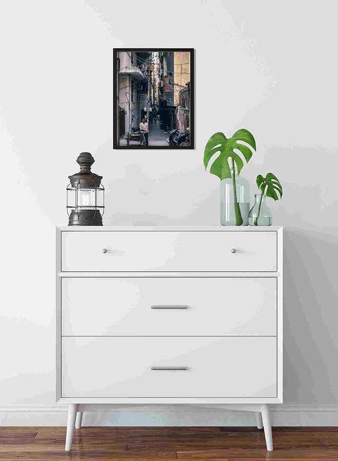 لوحة فنية لديكور الحائط برسمة رجل يقف بجوار دراجة ثلاثية العجلات متعدد الألوان 32x22x2سم - Image 2