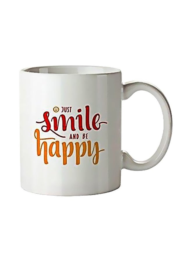 مج مزين بنمط مطبوع بعبارة "Just Smile And Be Happy" أبيض/ أصفر/ أحمر