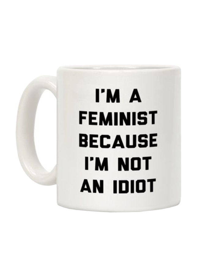 مج قهوة مزين بطبعة عبارة "I'm A Feminist Because I'm Not An Idiot" أبيض