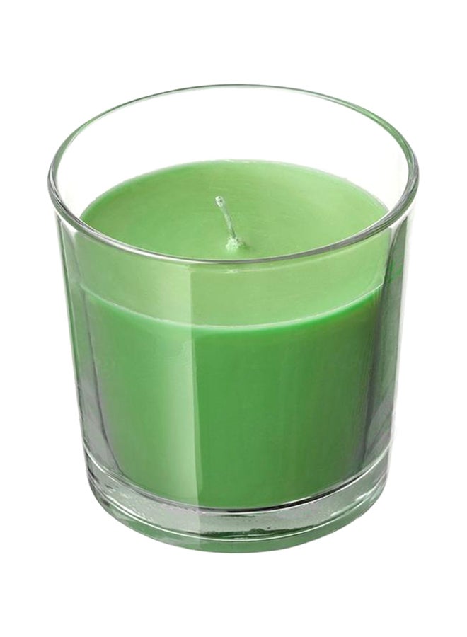شمع معطر في كوب زجاجي أخضر