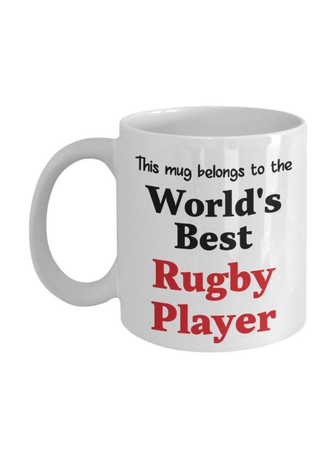 مج قهوة بطبعة عبارة "This Mug Belongs To The World's Best Rugby Playe" أبيض/أسود/أحمر 8x9.5x8سم