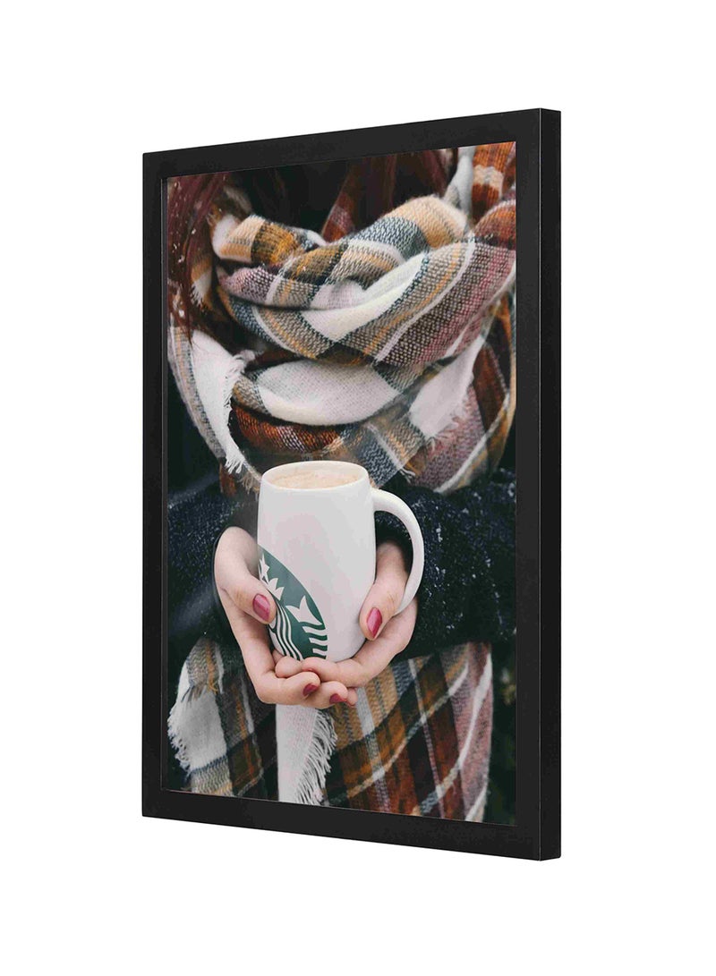 لوحة فنية بإطار خشبي لديكور الحائط بصورة فتاة ممسكة بمج قهوة عليه شعار ستاربكس في طقس بارد متعدد الألوان 33x43سم - Image 1