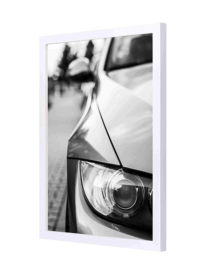 لوحة فنية بإطار خشبي تحمل صورة قريبة لمصباح أمامي لسيارة بي إم دبليو متعدد الألوان 33x43سم