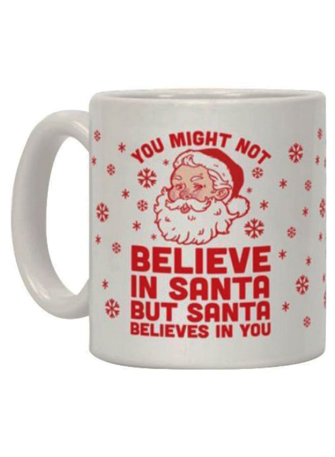 "مج قهوة بطبعة عبارة "You Mould Not Believe In Santa But Santa Believe In You" أبيض/أحمر